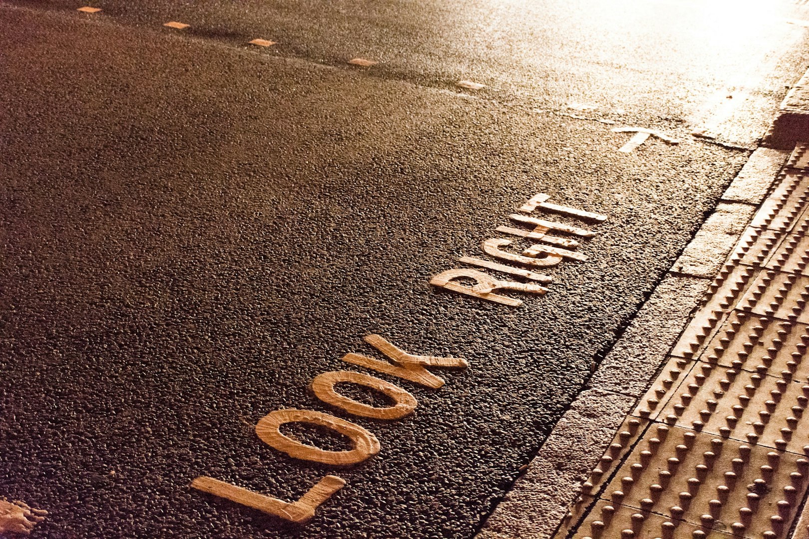 a close up of a street sign on the ground